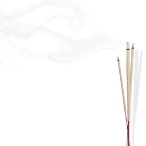 Three burning incense sticks with smoke on a white background.
