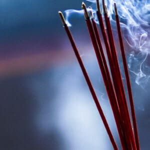 Burning incense sticks emitting fragrant smoke.
